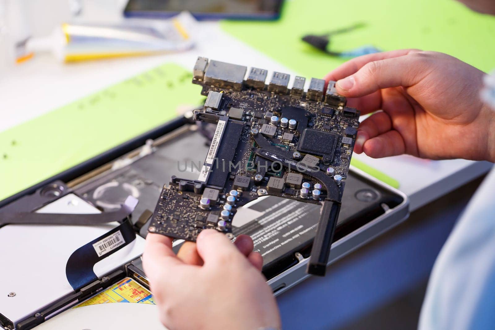 Professional computer and tablet repair shop or service. Close up of a computer board. Electronics concept. Detail from a laptop under repair