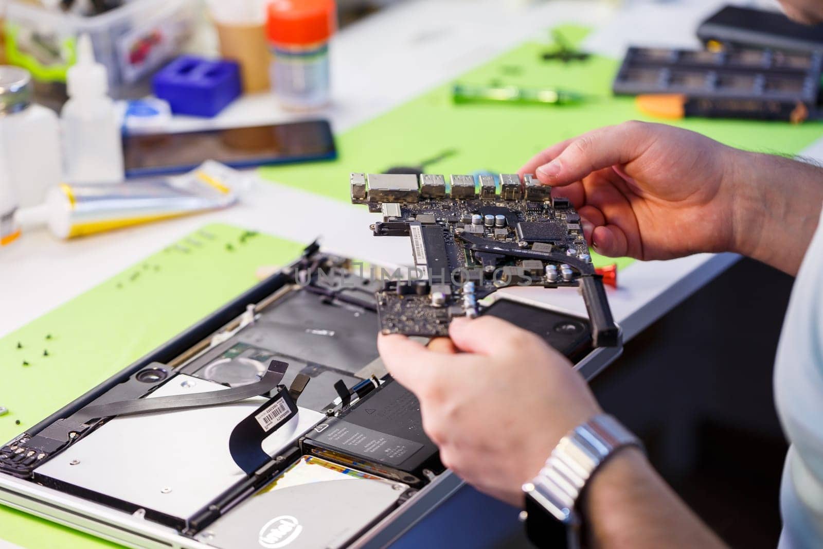 Professional computer and tablet repair shop or service. Close up of a computer board. Electronics concept. Detail from a laptop under repair
