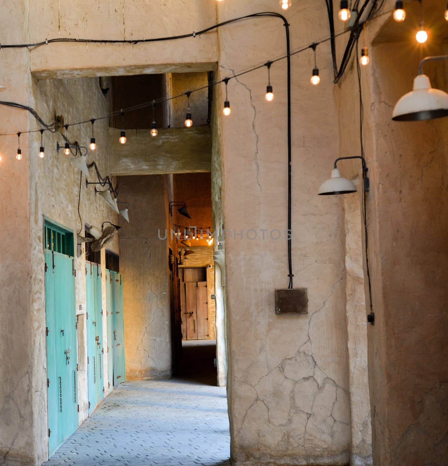 Narrow streets that create shade on a hot day in the old city of Dubai Creek and Bur district. Travel destinations and heritage village by Ekaterina34