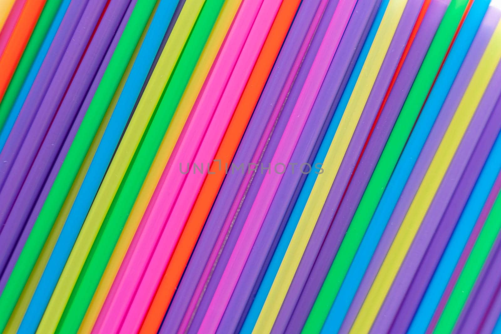 abstract background of bright multicolored cocktail tubes. Colorful tubes for background