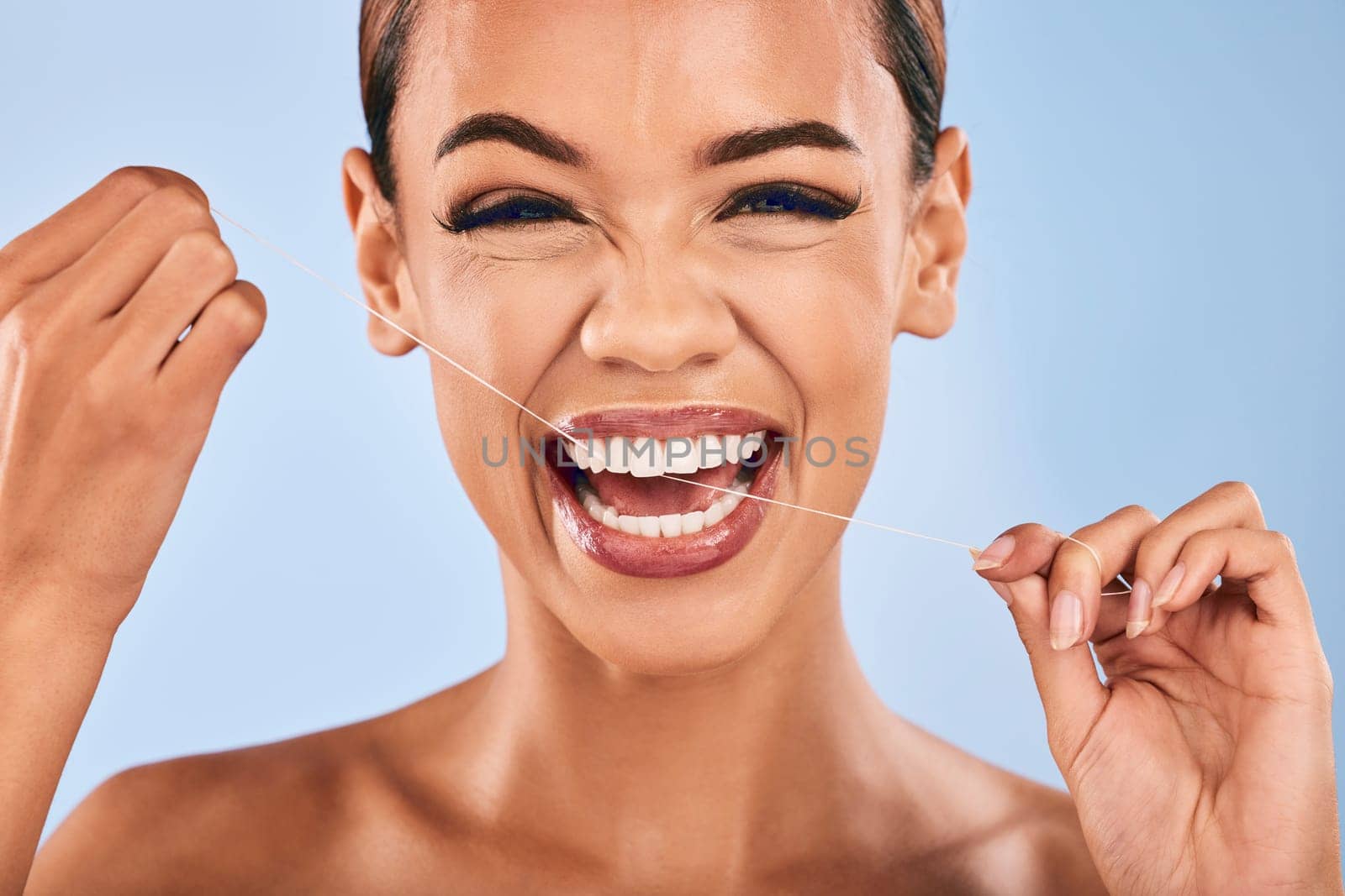 Happy woman, portrait and flossing teeth in dental, clean hygiene or healthcare against a studio background. Female person or model with smile in tooth whitening, floss or oral, gum or mouth cleaning.