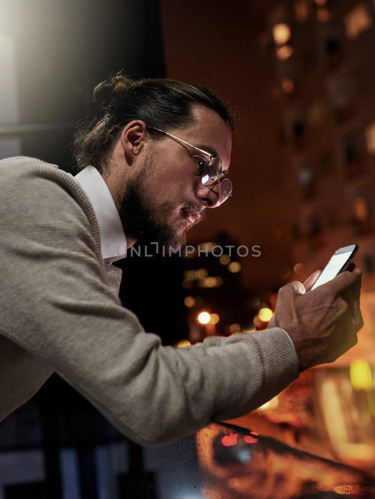 Phone, city and business man at night for research, internet website and social media on balcony. Technology, communication and male with smartphone for writing email, networking and chatting online by YuriArcurs