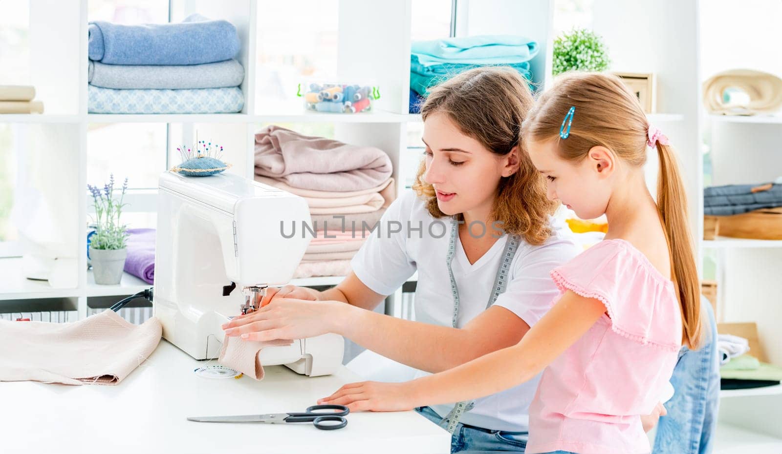 Little girl is taught to sew by tan4ikk1