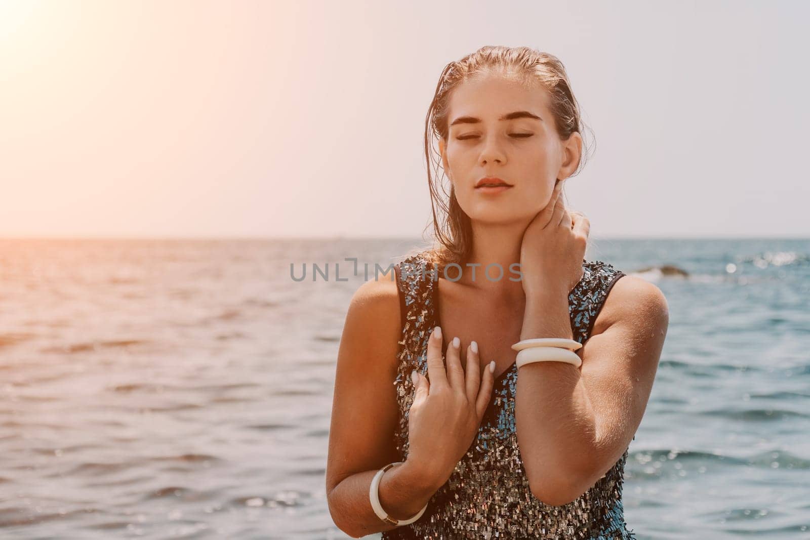 Woman summer travel sea. Happy tourist enjoy taking picture outdoors for memories. Woman traveler posing on the beach at sea surrounded by volcanic mountains, sharing travel adventure journey by panophotograph