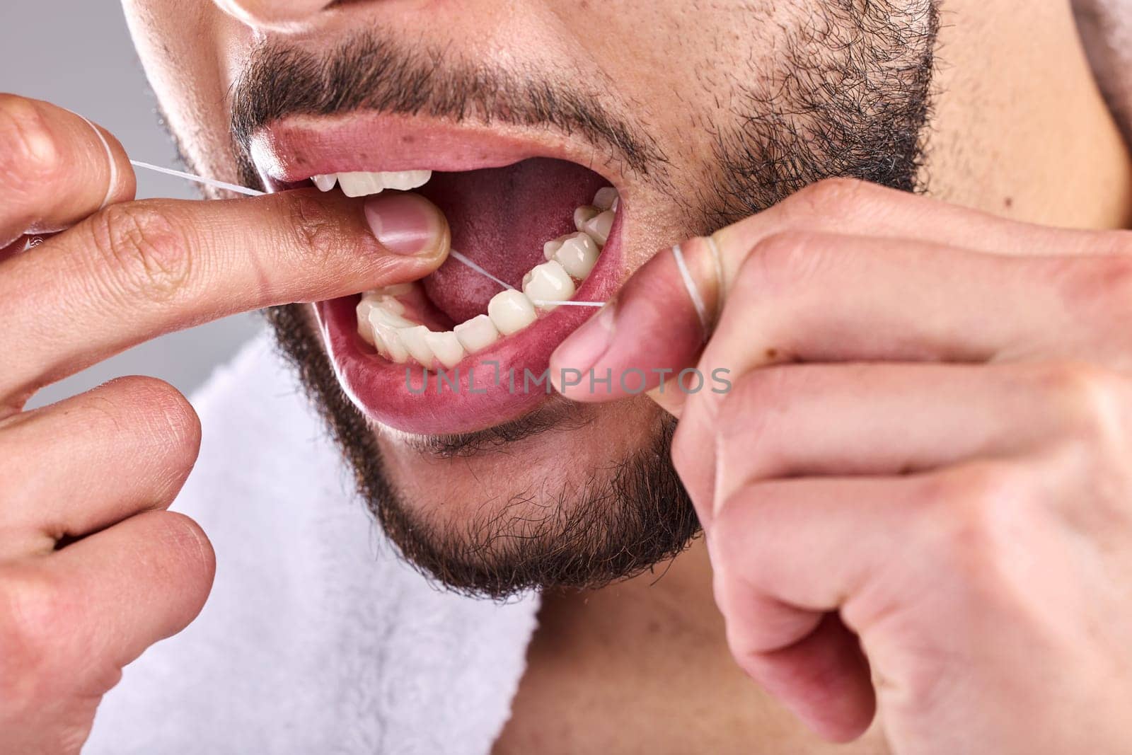 Mouth, dental and man floss teeth in studio isolated on a background for healthy hygiene. Tooth, flossing product and closeup of male model cleaning for oral wellness, fresh breath and gums