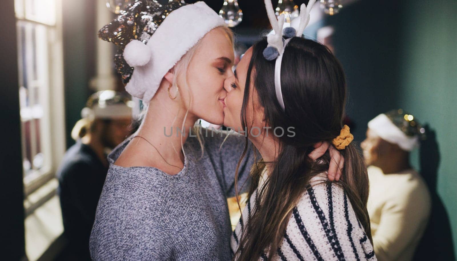 Christmas, kiss and love with lesbian couple at party for celebration, festive and holiday. Lgbtq, gay and dance with women partners at xmas event for romance, social and relax at reunion gathering.