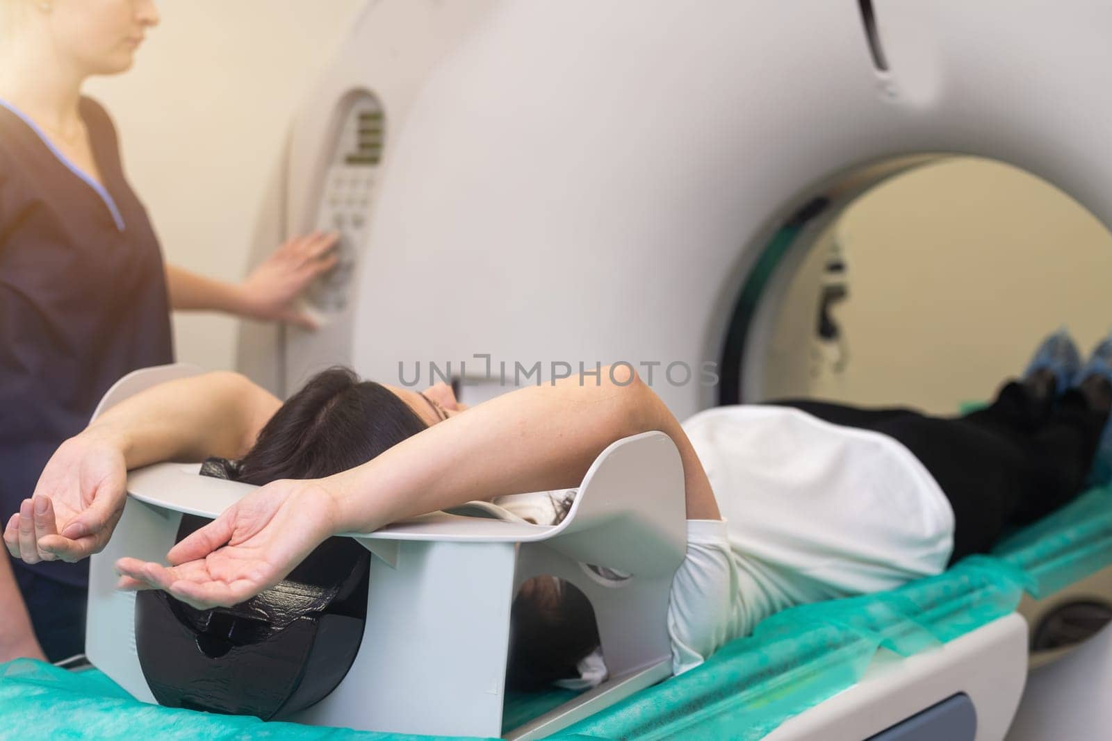 Doctor doing computed tomography for female patient stock photo. Medicine diagnostic concept by Andelov13