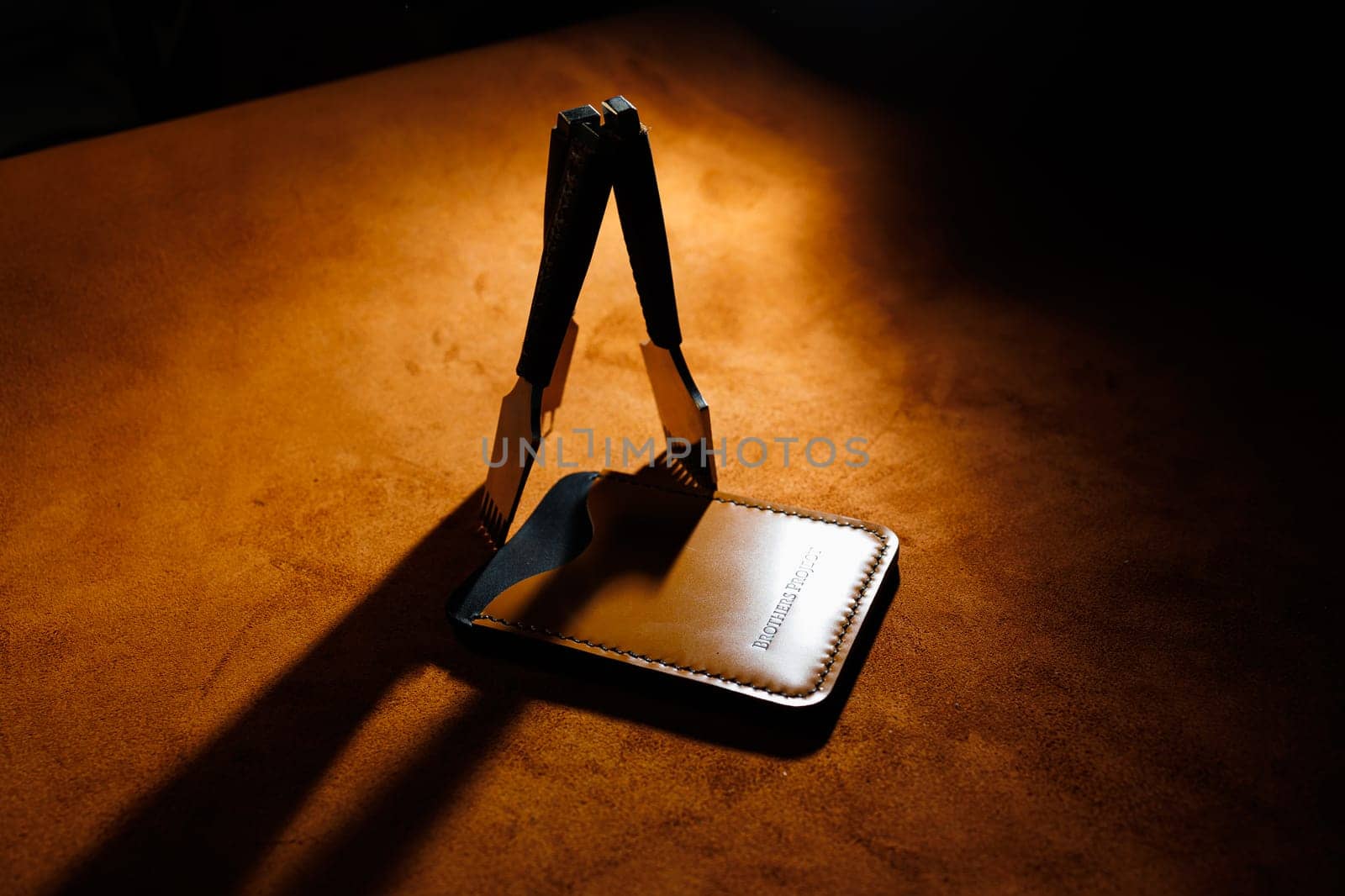 Tools for making leather goods and pieces of brown leather. Production of leather products. View from above