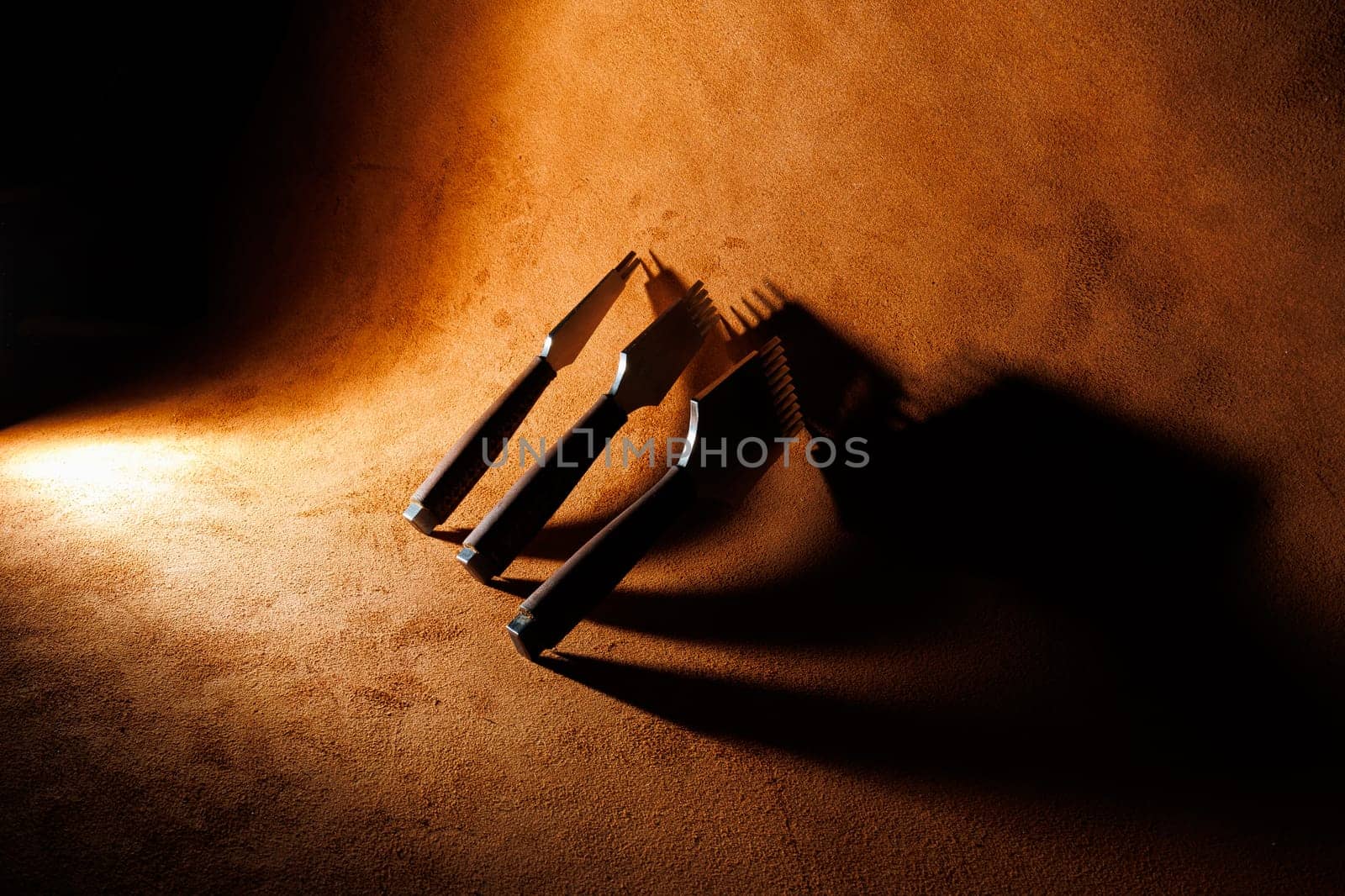 Tools for making leather goods and pieces of brown leather. Production of leather products. View from above
