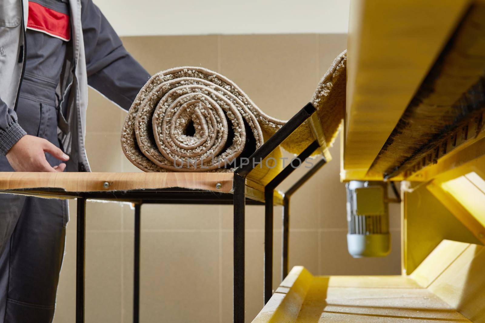 Man worker cleaning carpet on automatic washing machine equipment and dryer in the Laundry room