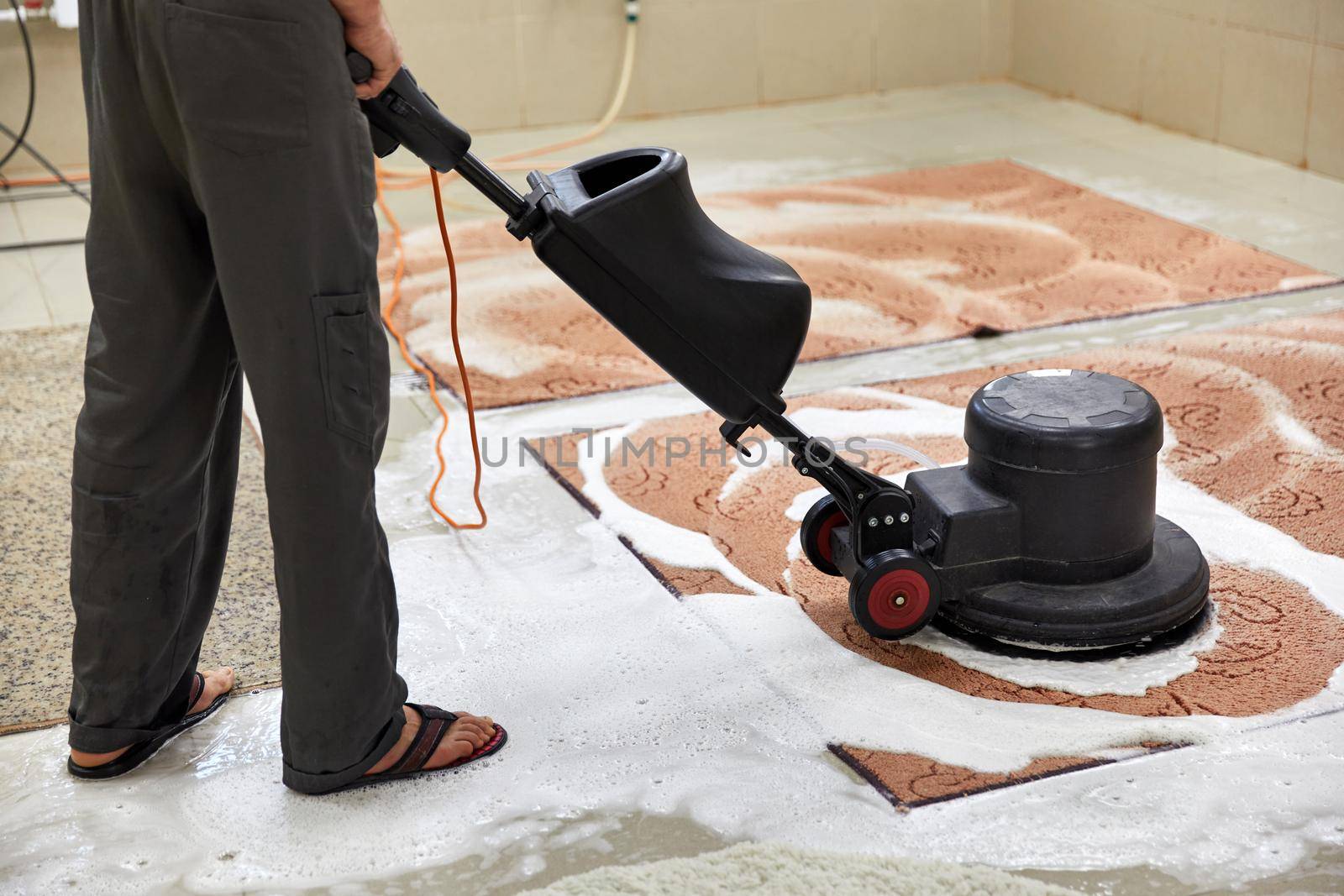 Carpet chemical cleaning with professionally disk machine. Early spring cleaning or regular clean up. High quality photo