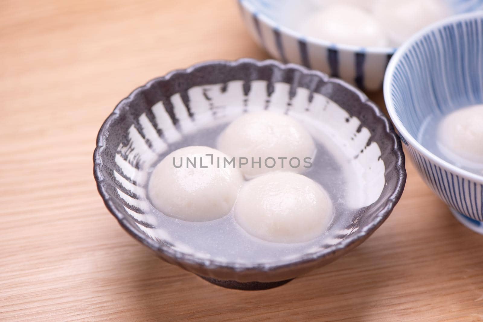 Delicious tang yuan, yuanxiao in a small bowl. Traditional festive food rice dumplings ball with stuffed fillings for Chinese Lantern Festival, close up.