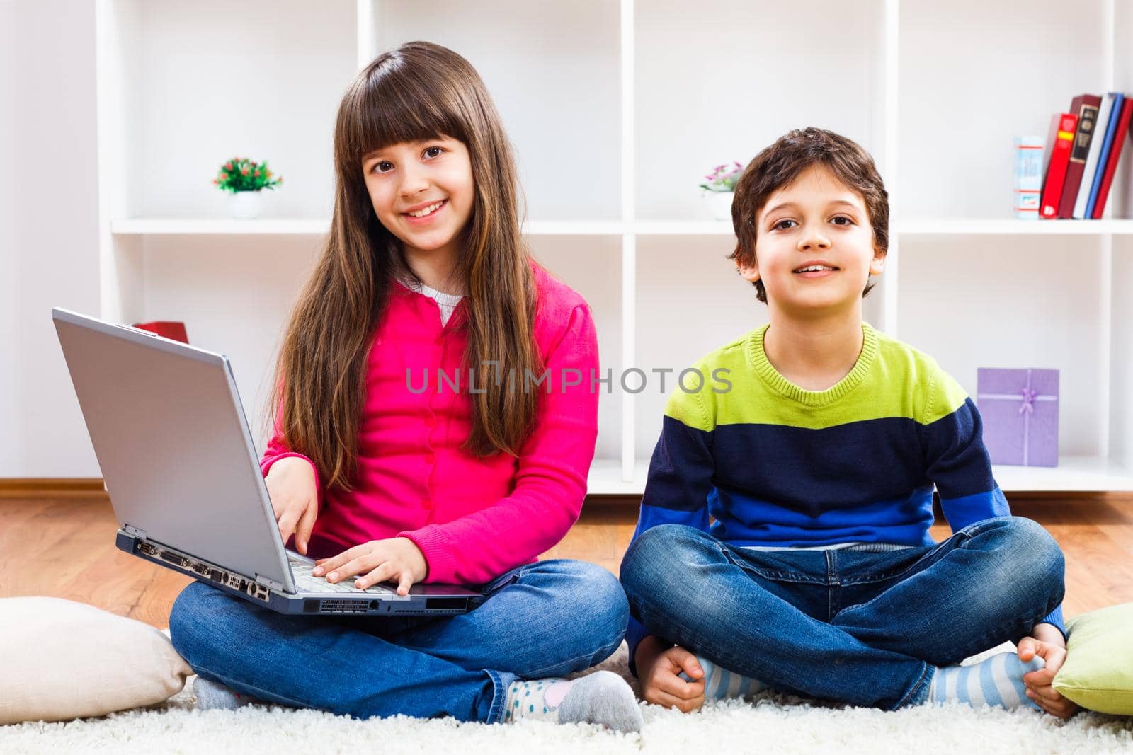 Image of children using laptop at home