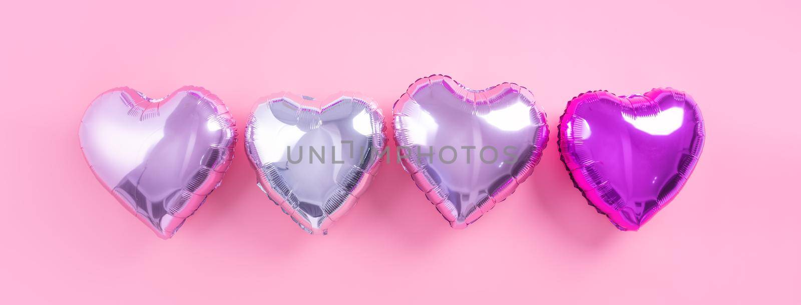 Valentine's Day romantic design concept - Beautiful real heart shape foil balloon isolated on pale pink background, top view, flat lay, overhead above photography. by ROMIXIMAGE