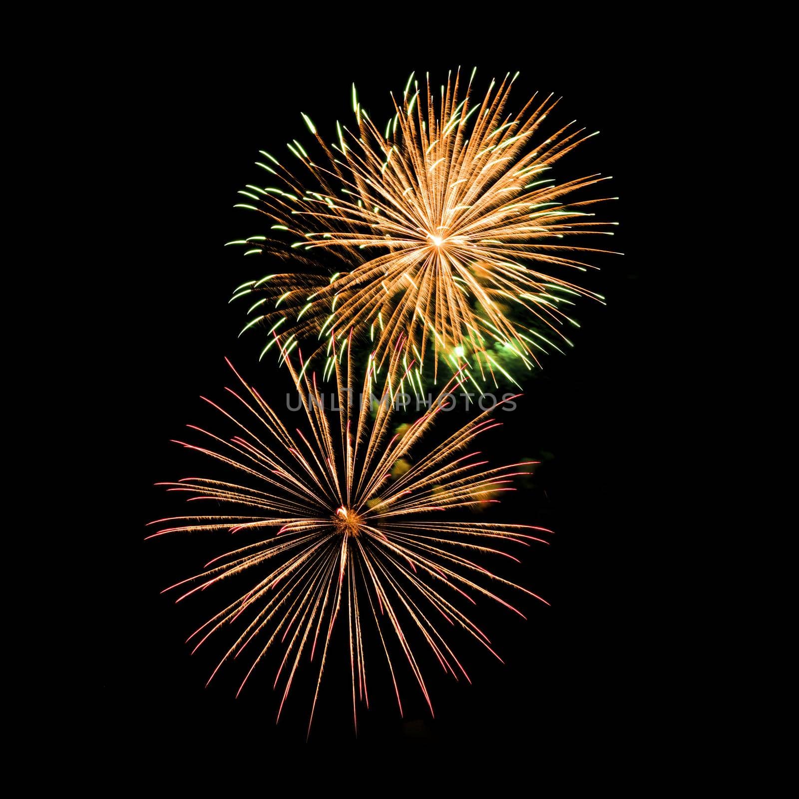 Colorful fireworks isolated on black sky background.