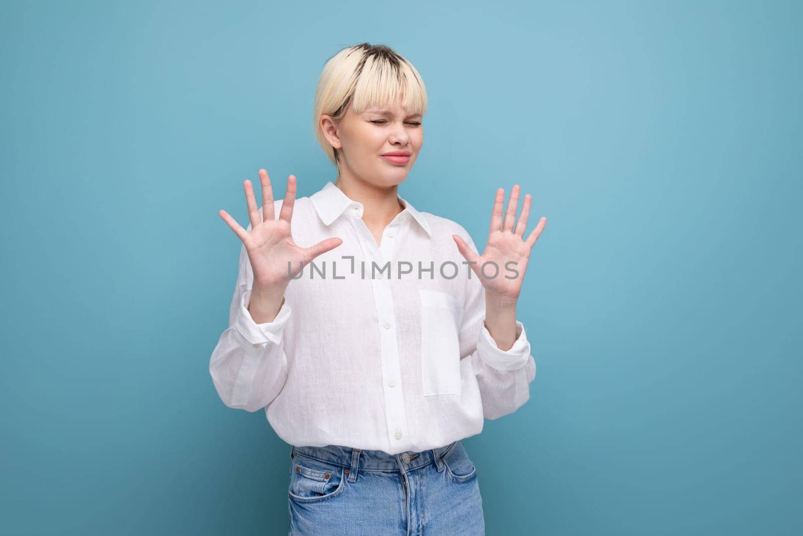 young pretty caucasian blond career woman in white blouse refuses job offer.