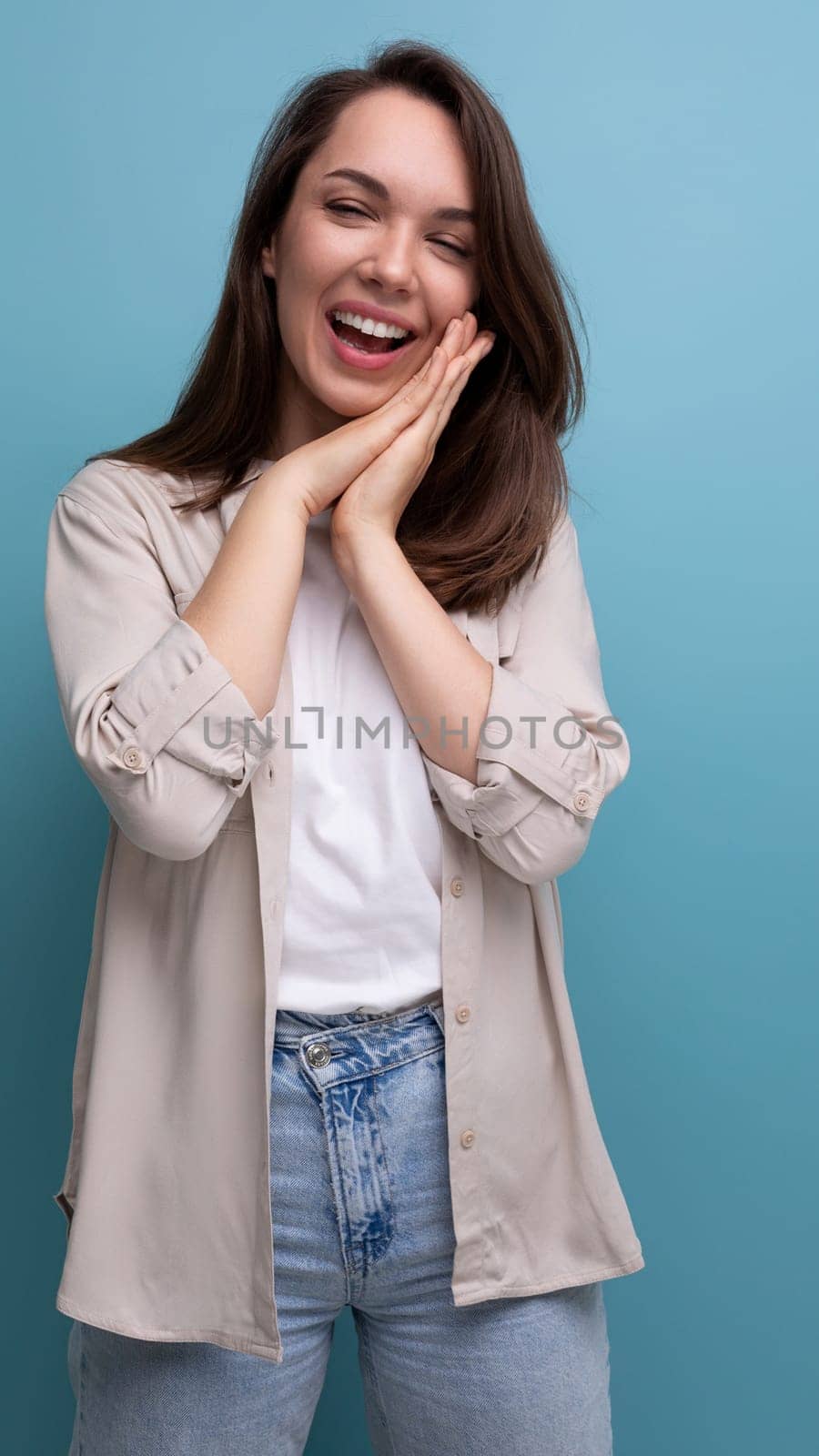 coquette romantic young brunette woman in shirt and jeans.