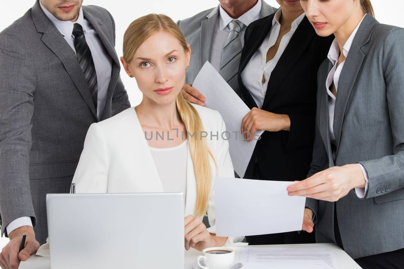 Female business leader talking to coworkers at meeting