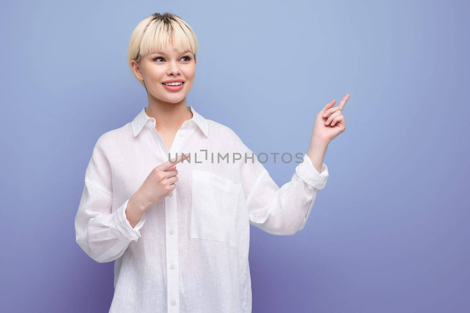 a stylish fashionable woman with a bob haircut dressed in a white shirt points with her hands in different directions. business concept by TRMK