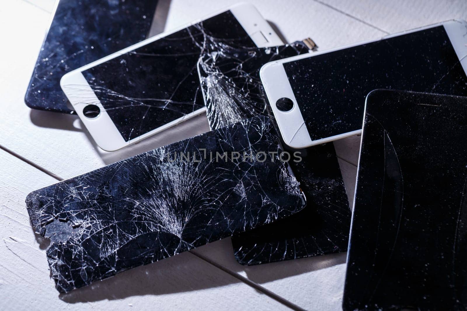 Mobile tablet device with a broken badly cracked shattered glass on the touch screen. Smart hardware part replacement, fixing concept