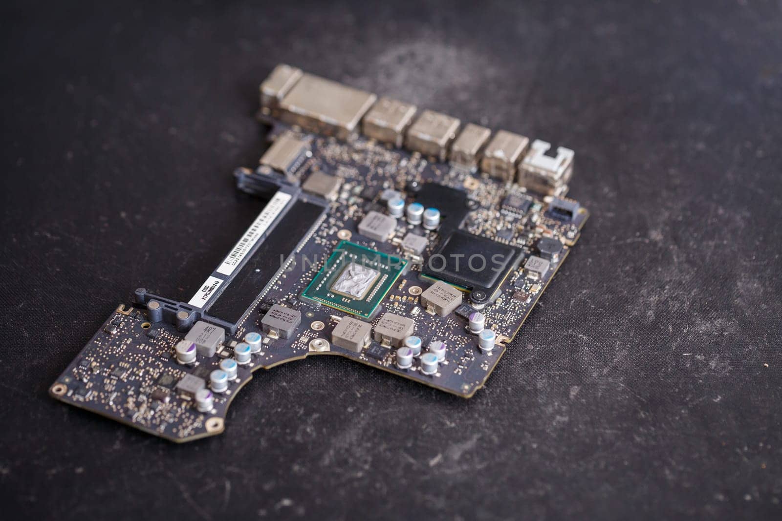 Professional computer and tablet repair shop or service. Close up of a computer board. Electronics concept. Detail from a laptop under repair
