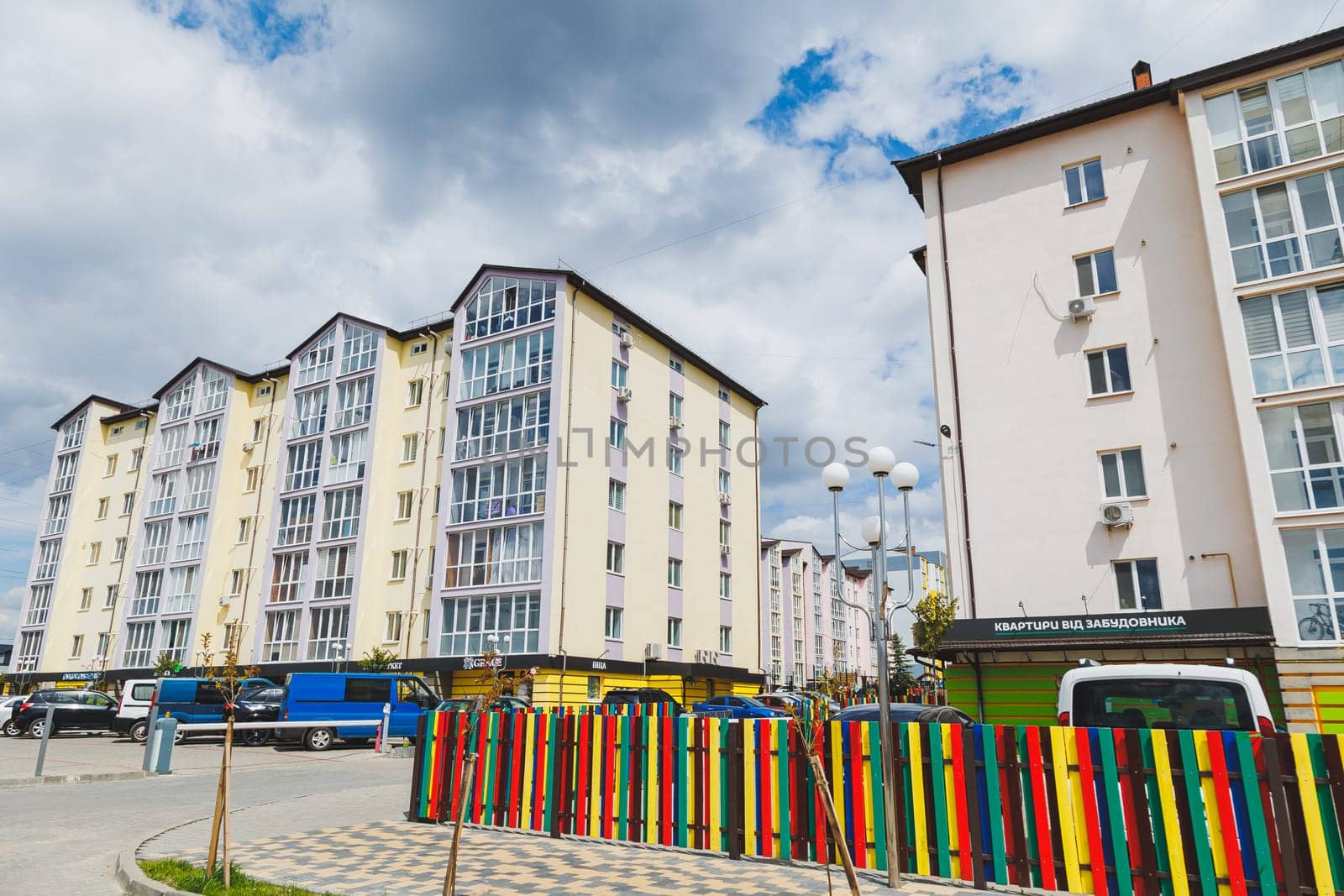 New-constructed unfinished multi-storey residential building. multi-storey residential house in brown and beige colors. Modern residential construction. Residential fund. Building on background of sky