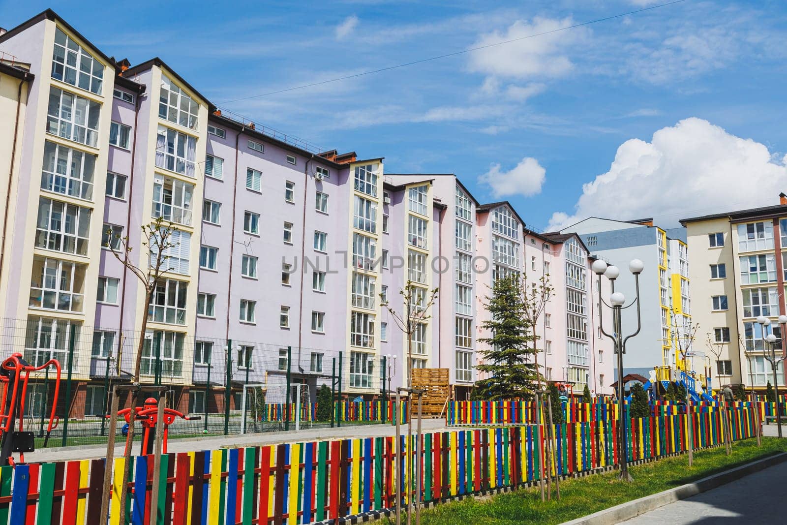 New residential high-rise buildings. Apartments with balconies in a new area. Modern residential buildings. Children's playground in the courtyard of a residential building.