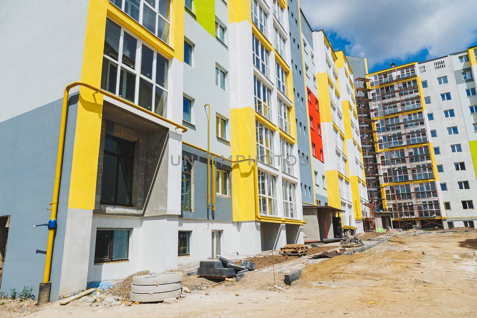 Detail in Modern residential flat apartment building exterior. Fragment of New luxury house and home complex. Part of City Real estate property and condo architecture. Copy space. Blue sky