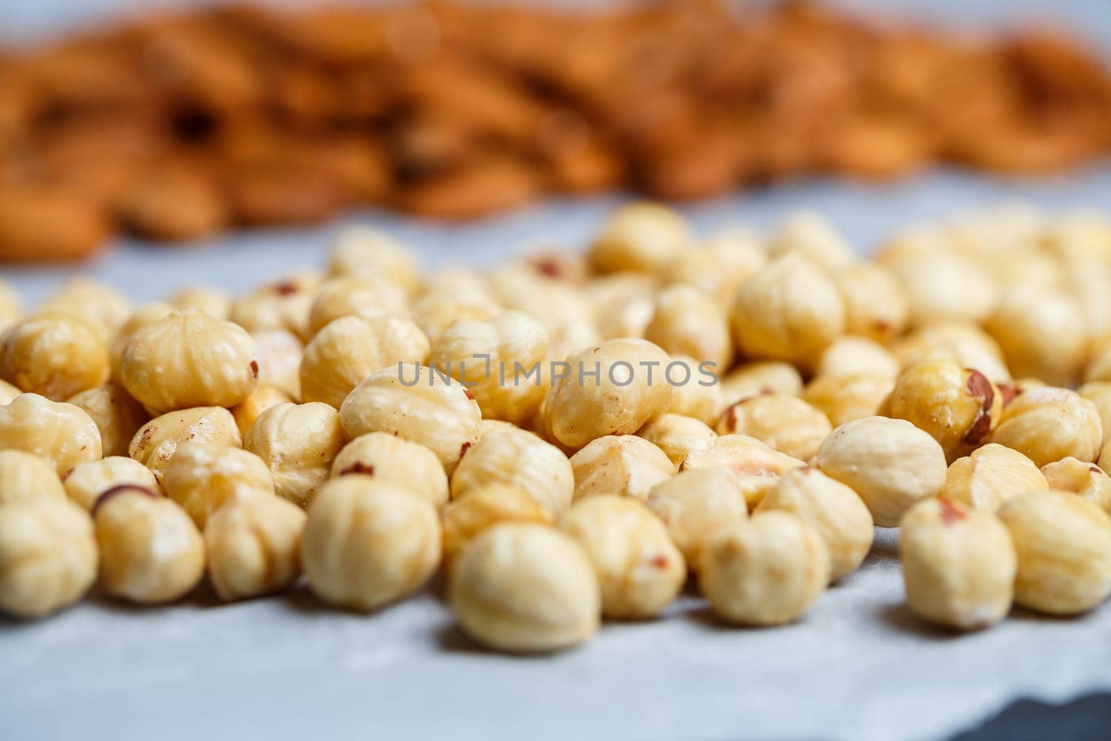 Roasted delicious nuts almonds and hazelnuts on a white background.