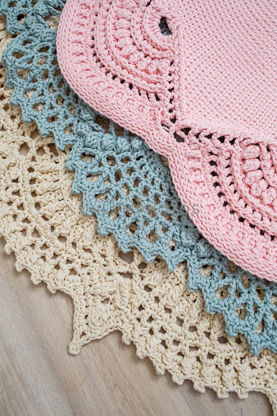 On the floor is a knitted cotton carpet, decorative floor carpets. top view handmade.