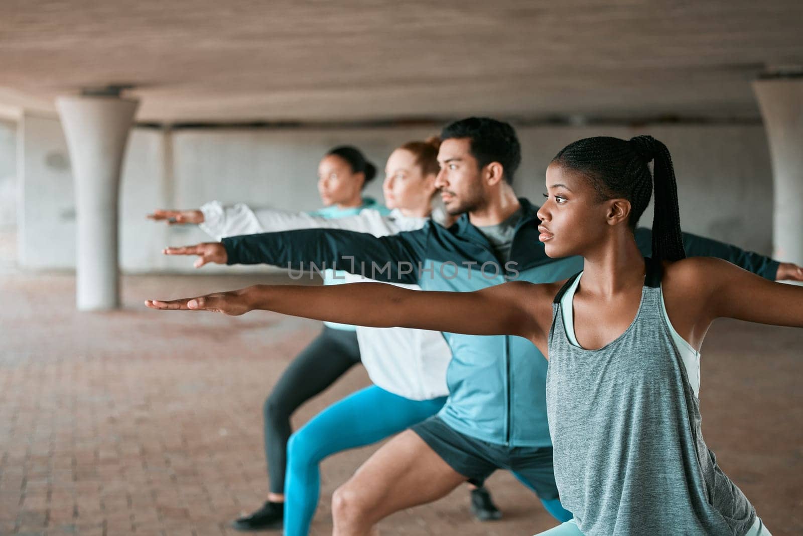 Team, exercise and friends stretching as a fitness club for sports, health and wellness in an urban class together. Sport, commitment and people training or group doing pilates workout in yoga by YuriArcurs