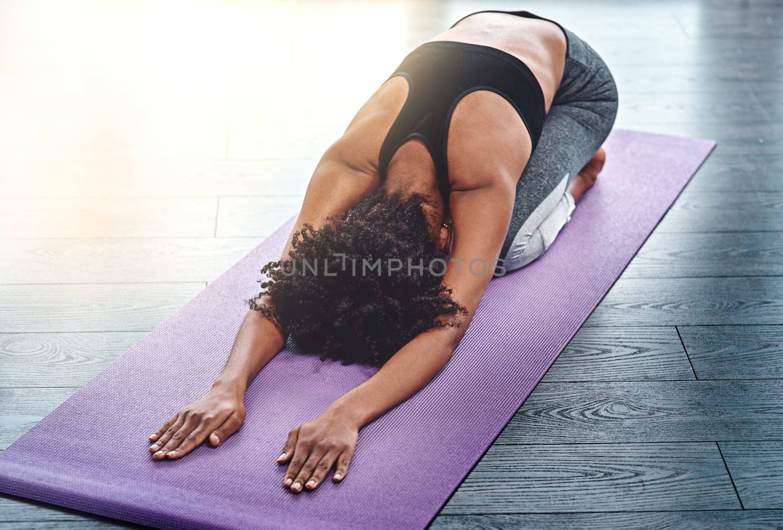 Yoga, workout and wellness with a woman in studio on an exercise mat for inner peace or to relax. Health, fitness and zen with a female athlete or yogi in the childs pose for balance or mindfulness by YuriArcurs