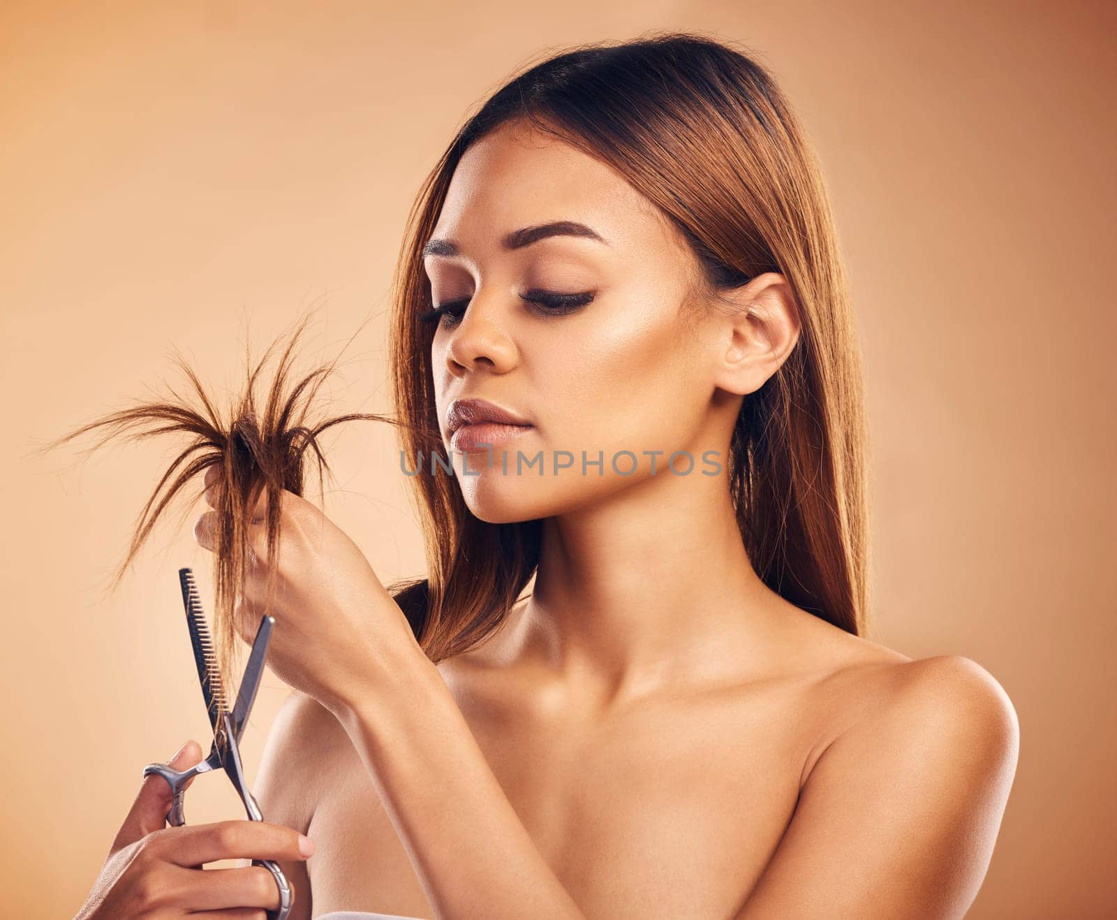 Woman cutting hair, split ends and beauty with haircare, damage and dry texture isolated on studio background. Female model, scissors for tips and cosmetic keratin treatment, haircut and hairstyle.