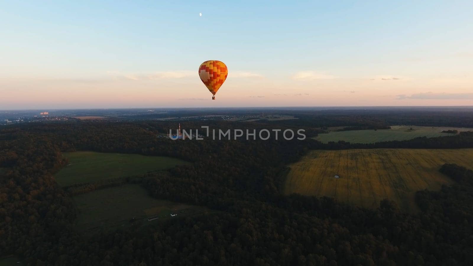 Aerial view Hot air balloon in the sky over a field in the countryside in the beautiful sky and sunset. Balloon silhouette with sunrise, Aerostat fly in the countryside.