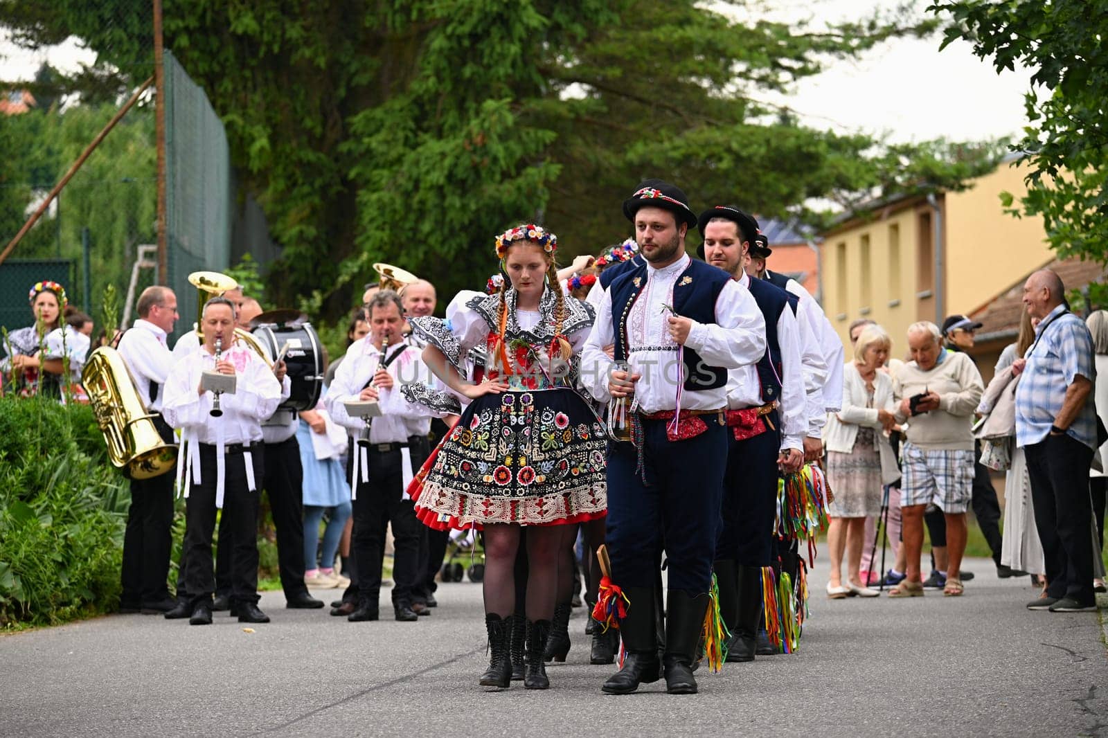 Brno - Bystrc, Czech Republic, 24 June, 2023. Traditional festivities of the feast of the feast in the Czech Republic. Food and drink festival. Girls and boys dancing in beautiful colourful traditional costumes. An old Czech custom of celebrating in villages. 