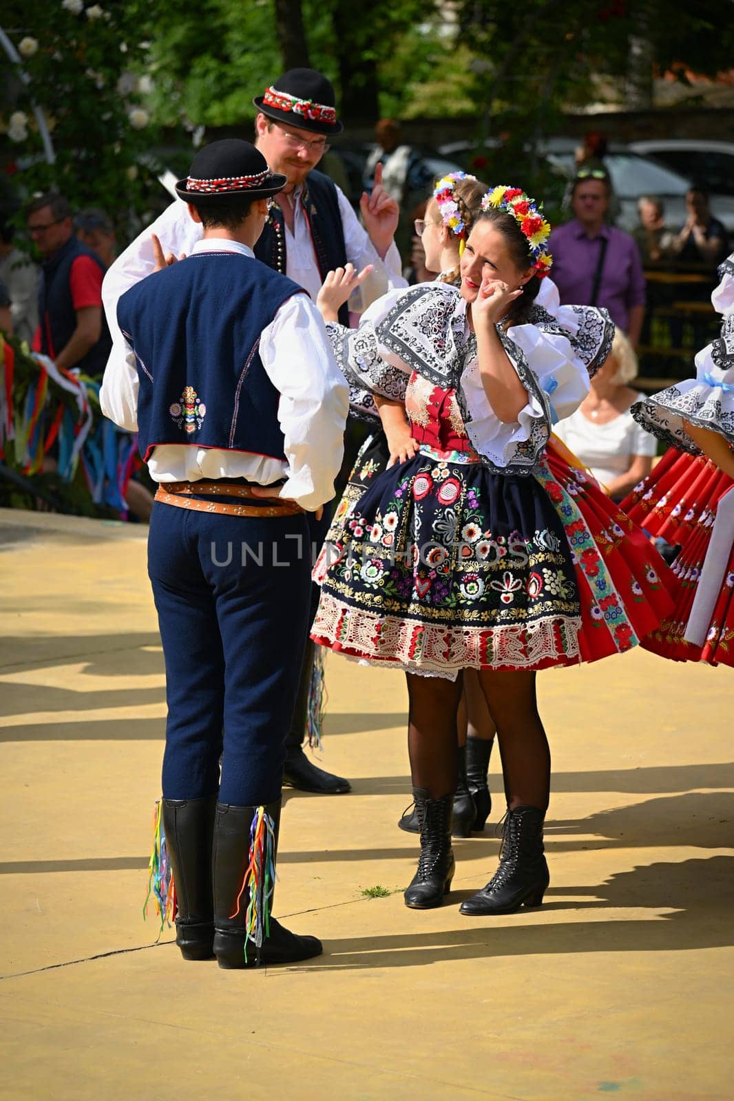 Brno - Bystrc, Czech Republic, 24 June, 2023. Traditional festivities of the feast of the feast in the Czech Republic. Food and drink festival. Girls and boys dancing in beautiful colourful traditional costumes. An old Czech custom of celebrating in villages.  by Montypeter