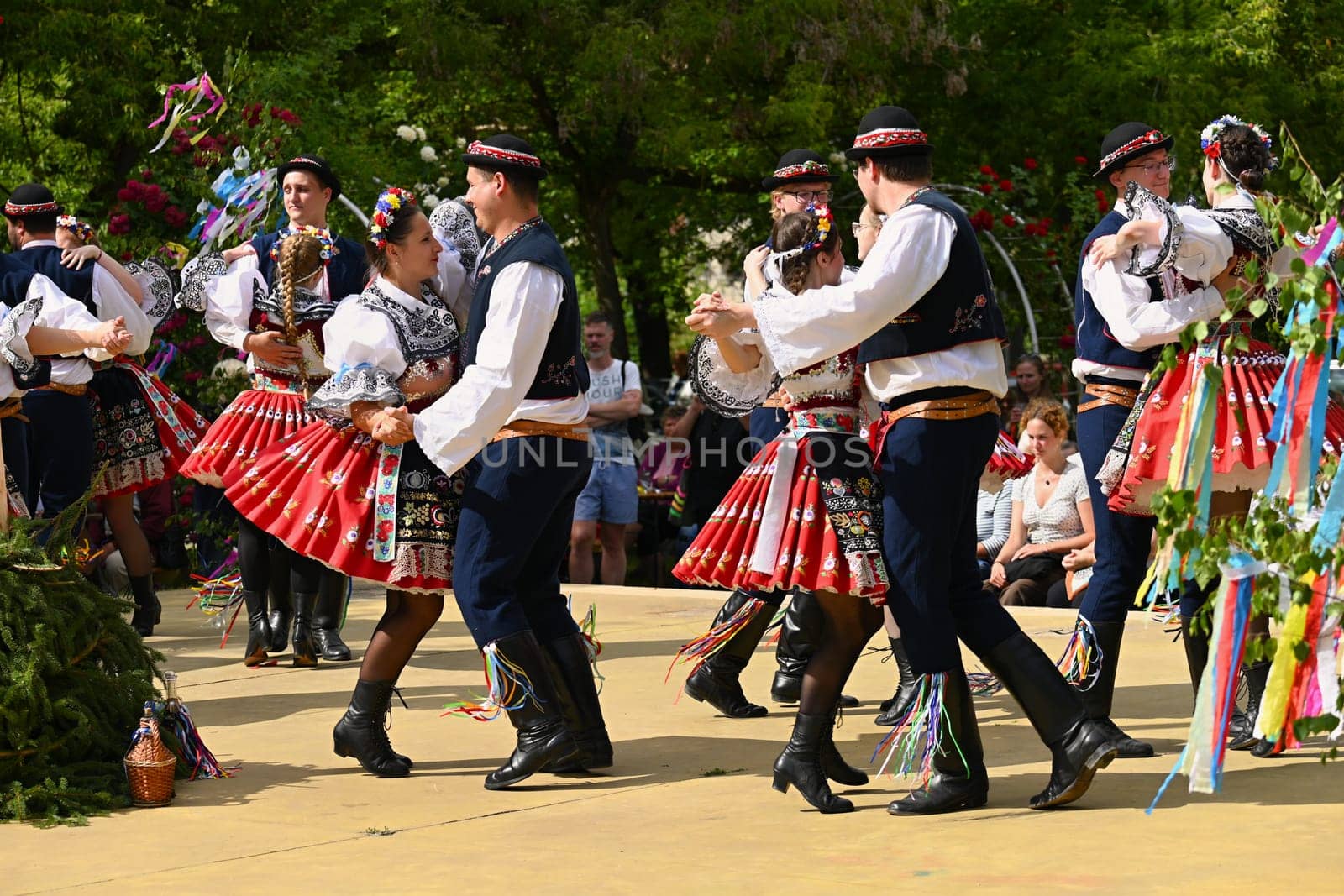 Brno - Bystrc, Czech Republic, 24 June, 2023. Traditional festivities of the feast of the feast in the Czech Republic. Food and drink festival. Girls and boys dancing in beautiful colourful traditional costumes. An old Czech custom of celebrating in villages. 