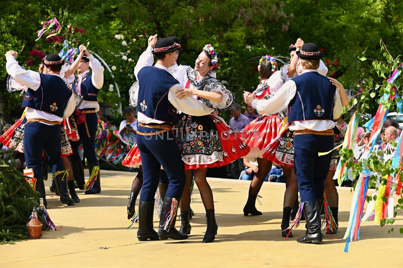 Brno - Bystrc, Czech Republic, 24 June, 2023. Traditional festivities of the feast of the feast in the Czech Republic. Food and drink festival. Girls and boys dancing in beautiful colourful traditional costumes. An old Czech custom of celebrating in villages.  by Montypeter