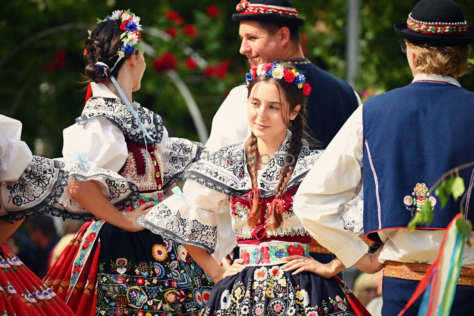 Brno - Bystrc, Czech Republic, 24 June, 2023. Traditional festivities of the feast of the feast in the Czech Republic. Food and drink festival. Girls and boys dancing in beautiful colourful traditional costumes. An old Czech custom of celebrating in villages. 