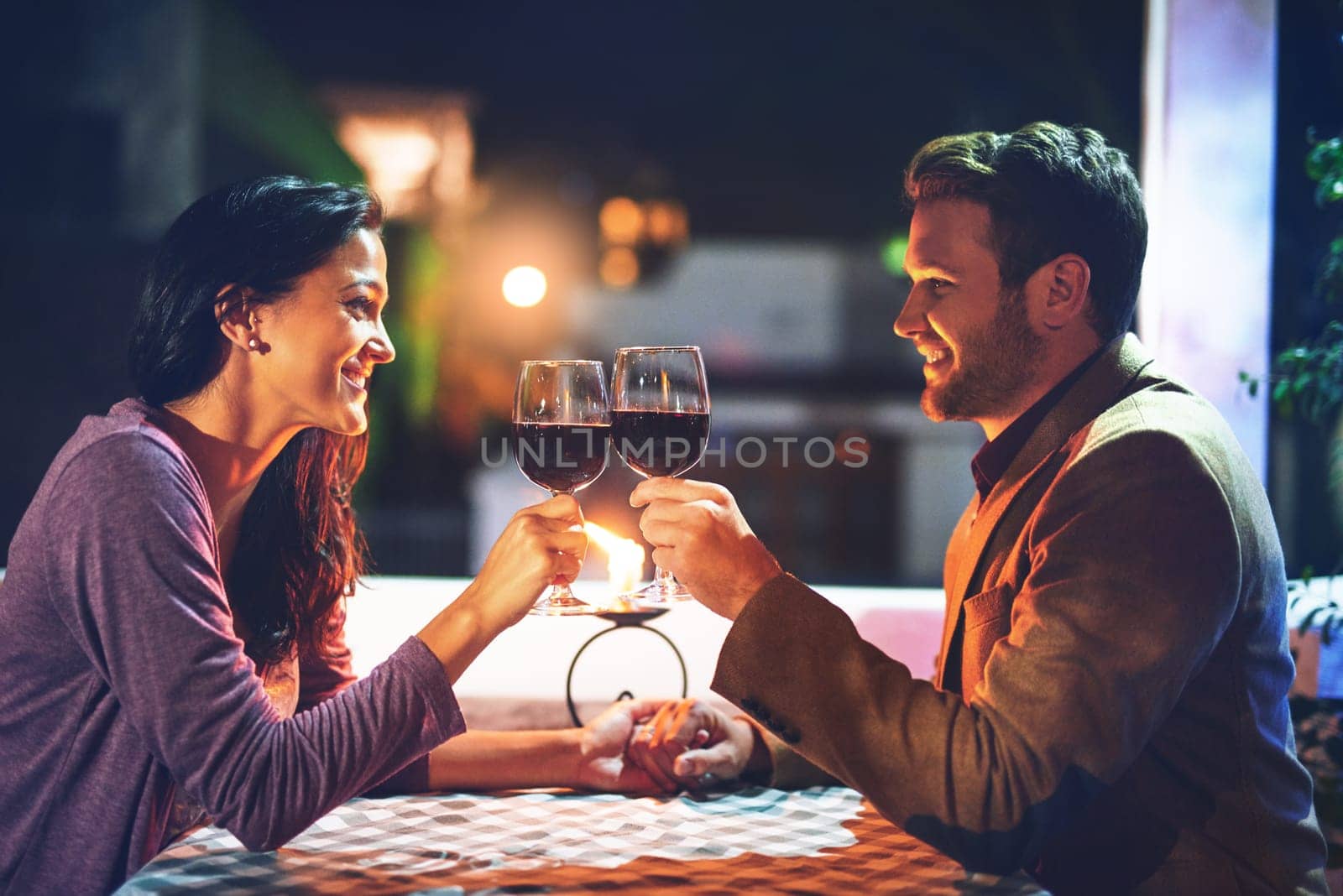 Cheers, wine and couple on date in restaurant, romance and happiness in celebration of love and drinks. Romantic honeymoon night, man and woman toast glasses in cafe, smile on dinner holiday travel. by YuriArcurs