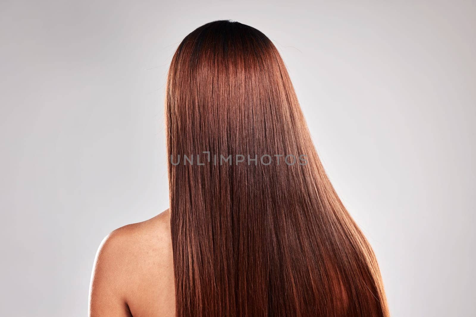 Hair care, health and beauty of girl with texture shine and smooth keratin style of people. Glossy aesthetic and glow treatment of person back view at isolated studio gray background