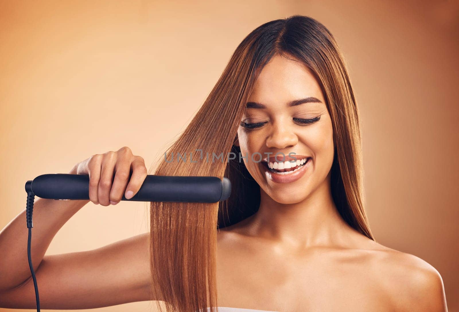 Woman, hair and beauty, flat iron and smile, haircare and keratin treatment isolated on studio background. Female model with highlights, electric straightener and heat, happy with growth and texture by YuriArcurs