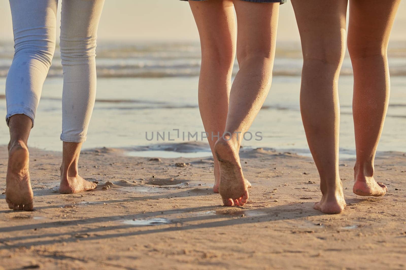 People feet, sand and walking on beach steps in summer vacation, holiday and sea travel together outdoors. Closeup group of friends, people and legs, foot and relax on ocean shore, freedom and calm by YuriArcurs