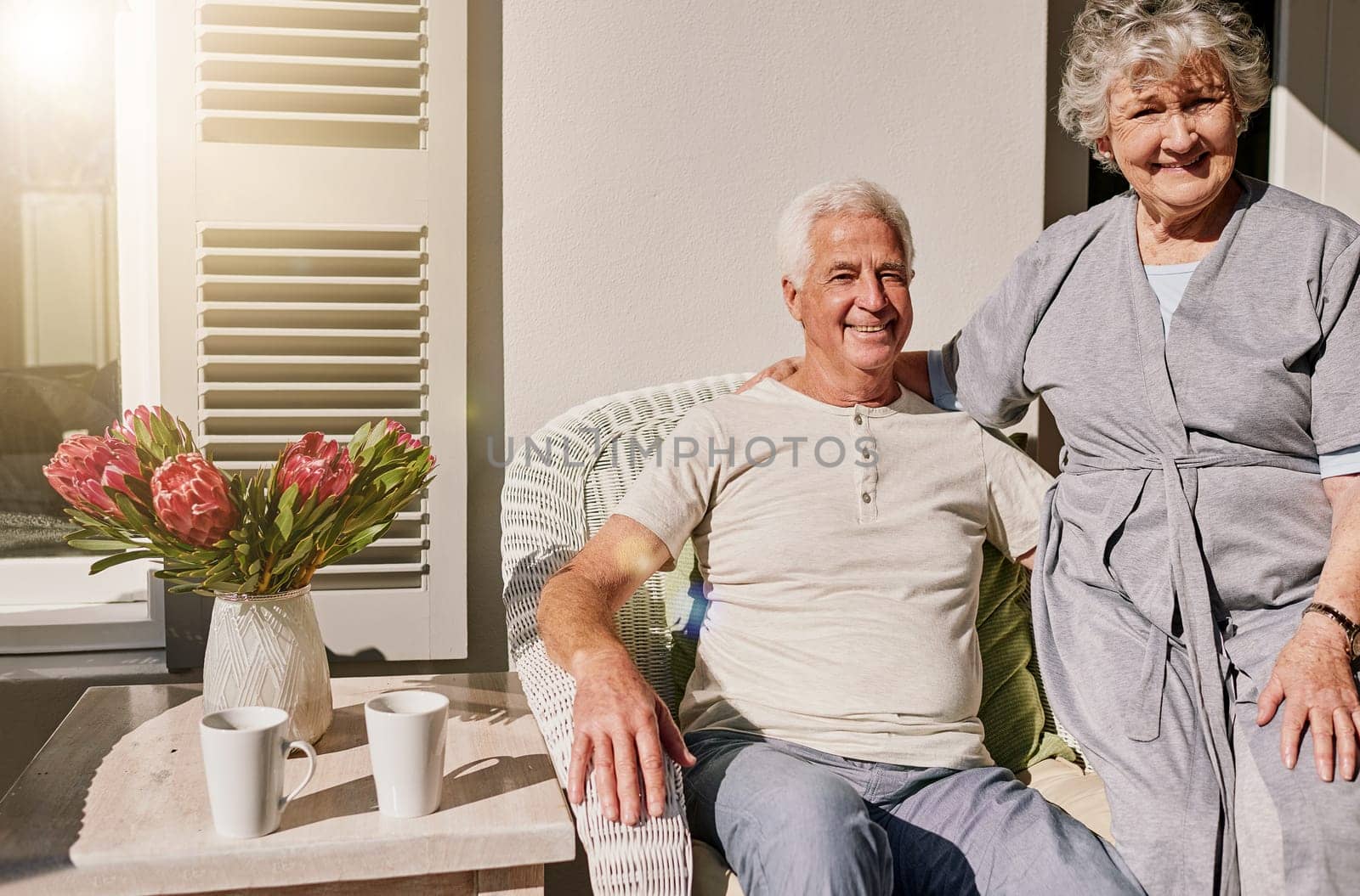 Morning, patio and portrait of senior couple enjoying bonding, quality time and relax on deck. Love, retirement home and happy elderly man and woman smile together for happiness, romance and marriage.