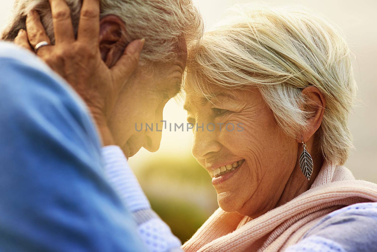 Love, forehead and senior couple outdoor, relationship and romance with happiness, retirement and bonding. Partners, mature man and old woman in a park, hug and retired with marriage and anniversary.