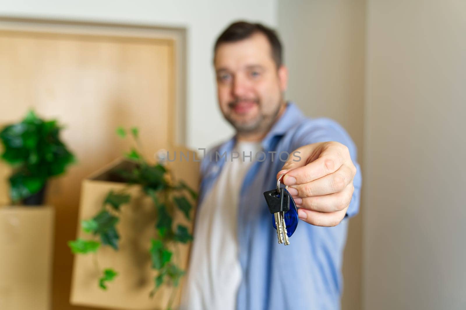 Couple showing keys to new apartment. real estate mortgage, loan concept. moving in new house by PhotoTime