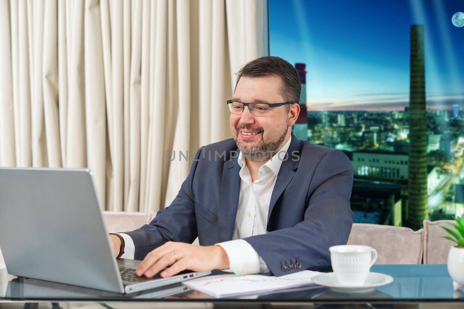 Happy businessman working on laptop in home office. financial investor working in the office. Accountant working on consolidated financial report of corporate operations.