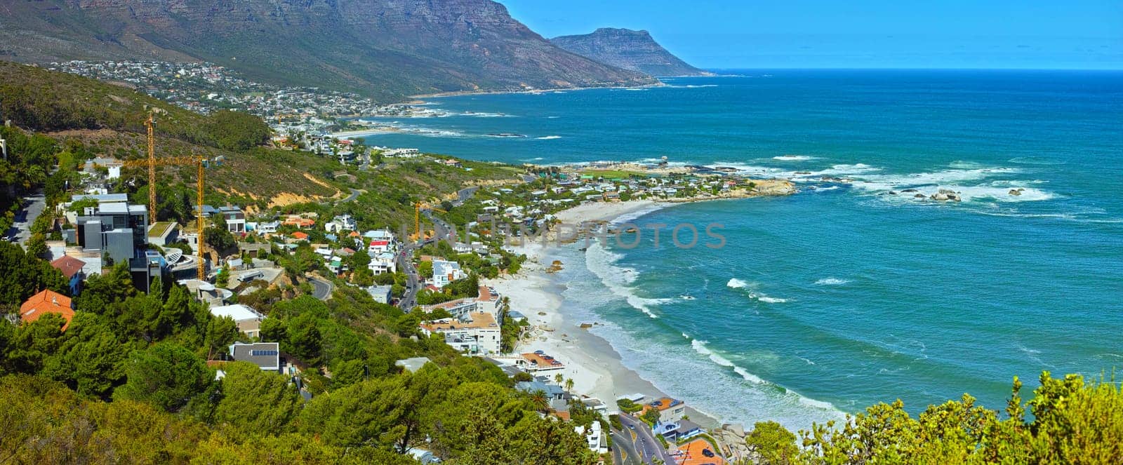 Mountain, nature and city by beach in South Africa for tourism, traveling and global destination. Landscape, background and scenic view of ocean by urban town for adventure, vacation and holiday.