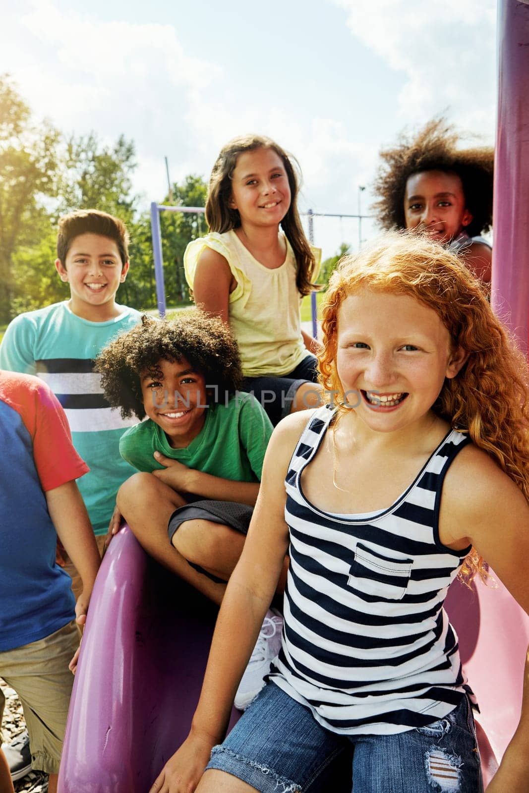 The park is our favourite summer hangout. Portrait of a group of diverse and happy kids hanging out together outside. by YuriArcurs