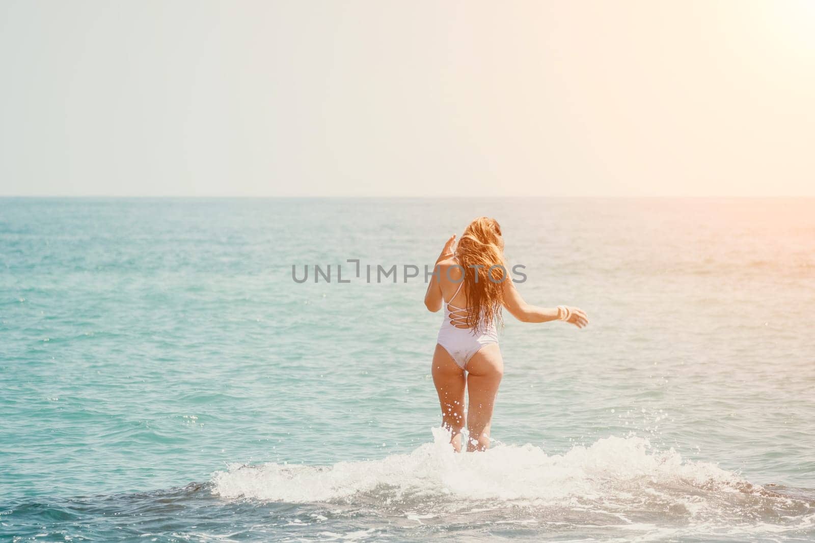 Woman sea yoga. Back view of free calm happy satisfied woman with long hair standing on top rock with yoga position against of sky by the sea. Healthy lifestyle outdoors in nature, fitness concept by panophotograph